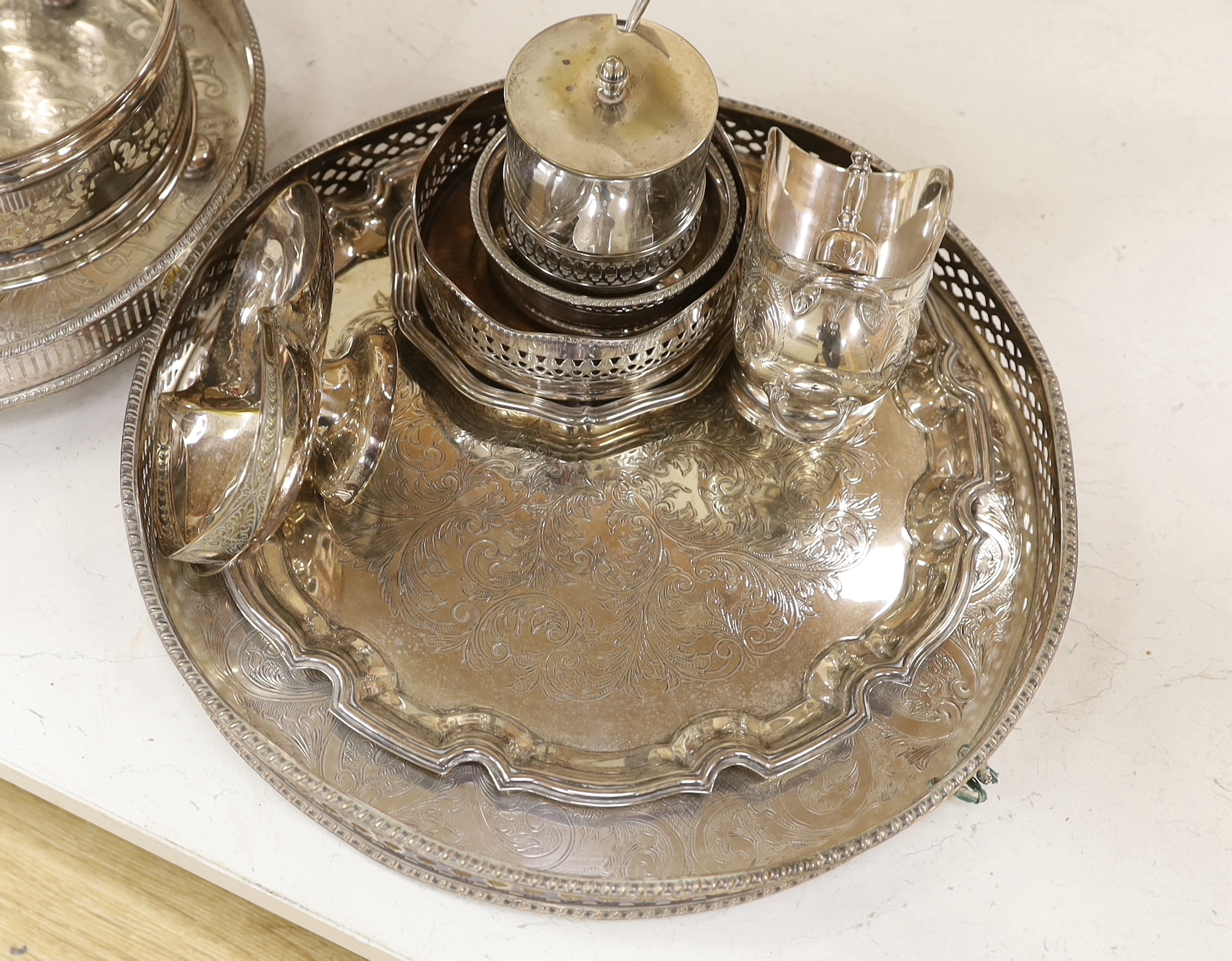 A quantity of silver plate including two trays with pierced galleries, a wine coaster, condiment serving pots, etc.